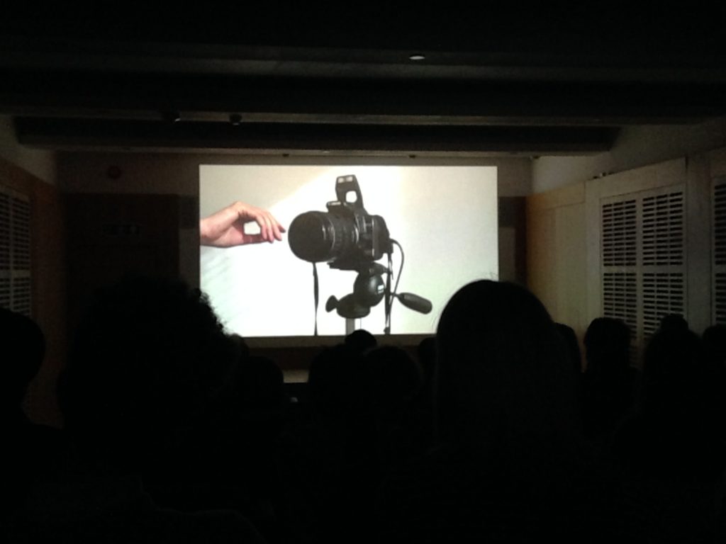 Image still of camera and hand on screen