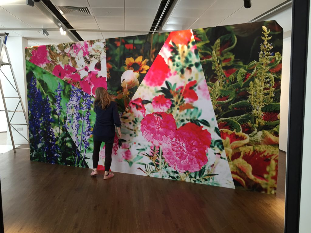 Photo collaged wall of bright flowers