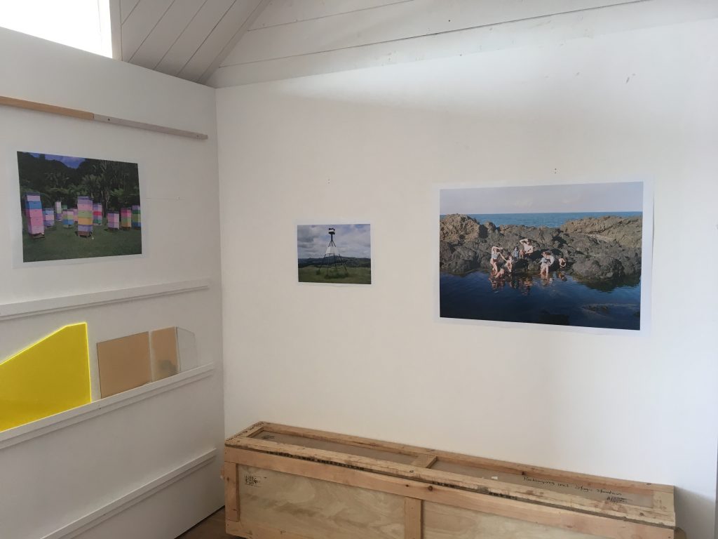 Photograph of studio with 3 photographs of a family round a rock pool