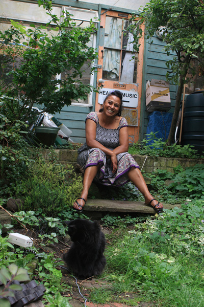 Woman in garden with black cat